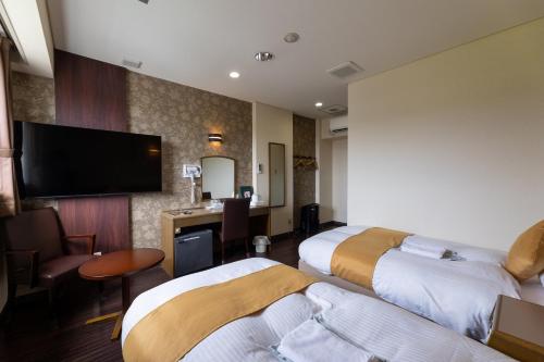 מיטה או מיטות בחדר ב-セントラルホテル高萩