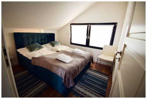 a bedroom with a large bed with a window at Krzaczasty Zakątek in Zdziary