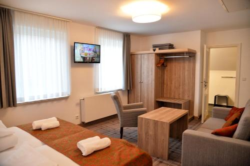 a living room with a couch and a table at Hotelanlage Starick in Lübbenau