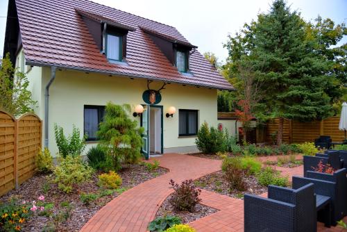 a house with a brick walkway in front of it at Hotelanlage Starick in Lübbenau
