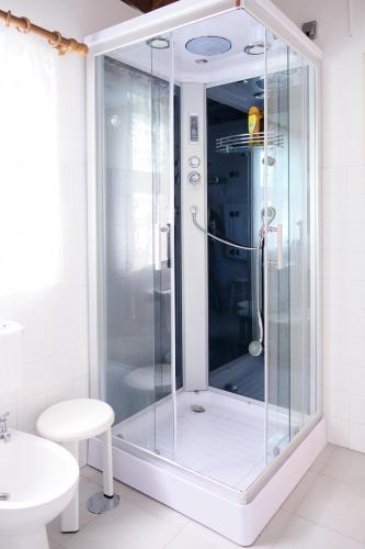 a shower with a glass door in a bathroom at Casa D'Alfaias in Nordeste