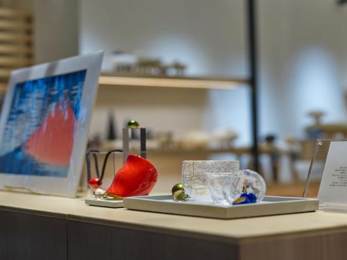 a desk with a laptop computer and other items on it at Portom International Hokkaido in Chitose
