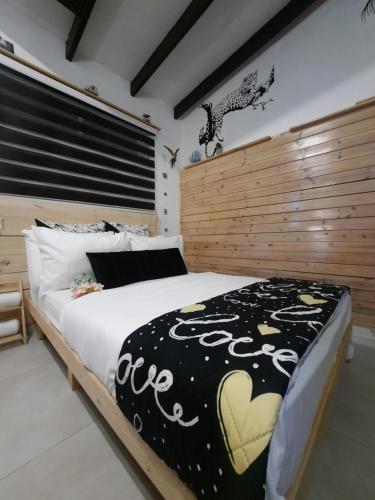 a bedroom with a large bed with a wooden headboard at AN edom suite in Eilat