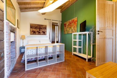 a bedroom with a bed and a green wall at L'orto di Hans in Soriano nel Cimino