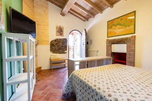 a bedroom with a bed and a fireplace at L'orto di Hans in Soriano nel Cimino