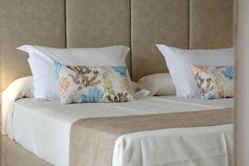 a bed with two pillows on top of it at Hotel Las Arenas in Can Pastilla