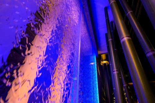 a purple and blue room with a glass wall at BAMBOO GARDEN Shinyokohama only Adult in Yokohama