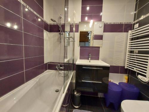 a bathroom with a tub and a sink and a shower at Appartement La Plagne-Tarentaise, 2 pièces, 5 personnes - FR-1-353-114 in La Plagne Tarentaise