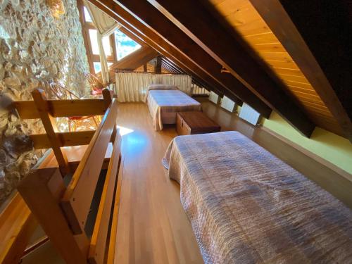 an attic room with two beds and a staircase at Casa Sansón in Chía