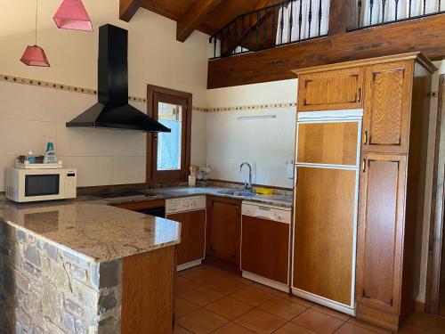 a kitchen with wooden cabinets and a counter top at Casa Sansón in Chía