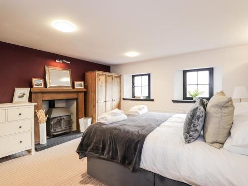 a bedroom with a large bed and a fireplace at Mary Ann Apartment in Inverness