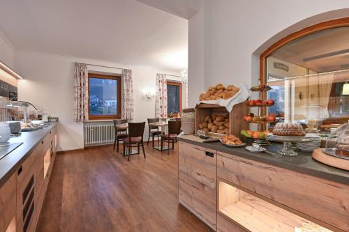 a kitchen with a counter with food on it at Hotel Ruchti - Zeit für mich in Füssen