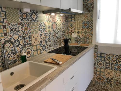 una cucina con lavandino e piastrelle sul muro di Apartamento Los Laureles - El Fraile ad Arona
