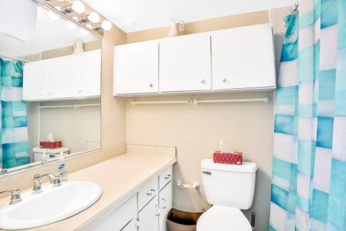 a bathroom with a sink and a toilet and a mirror at Blue Umbrella in Daytona Beach Shores