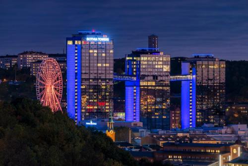 a city lit up at night with a ferris wheel at Gothia Towers & Upper House in Gothenburg