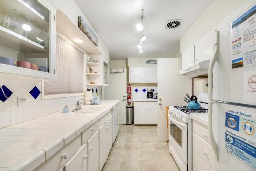 a kitchen with white cabinets and a refrigerator at Beach Rendezvous in Seaside