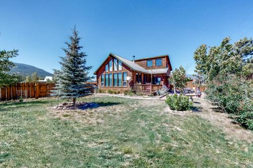 a large wooden house with a tree in the yard at The Norma Charles in South Fork
