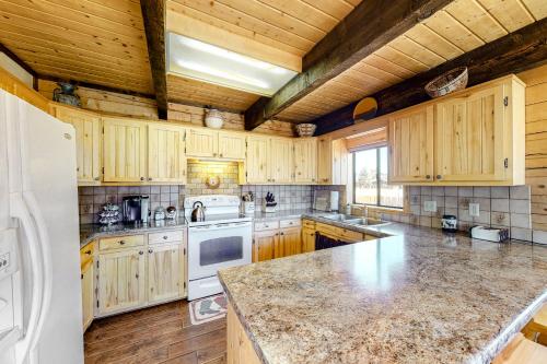 a kitchen with wooden cabinets and a marble counter top at The Norma Charles in South Fork