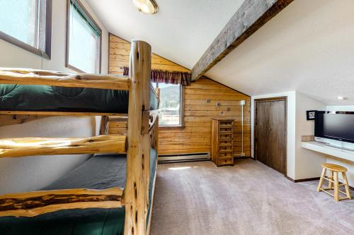 a room with two bunk beds and a tv at The Norma Charles in South Fork