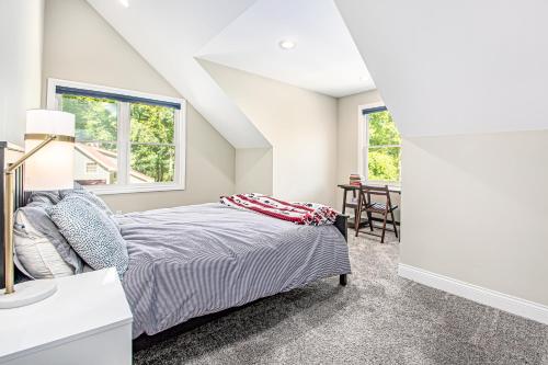 a bedroom with a bed and a desk and two windows at Friendly Farms in Lakeside
