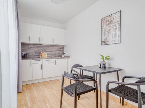 a kitchen and dining room with a table and chairs at Limehome Dresden Wallstraße - Digital Access in Dresden