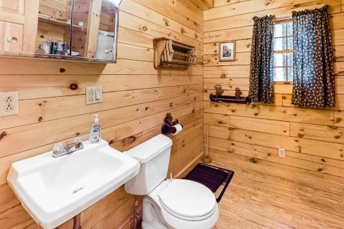 a bathroom with a white sink and a toilet at Lake View Cottage in Leeds