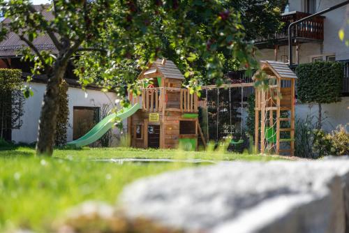 a set of wooden play structures in a yard at AlpenLiving in Mayrhofen