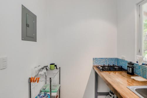 a kitchen with a counter and a refrigerator at Lost Pools Bungalow in Uvita