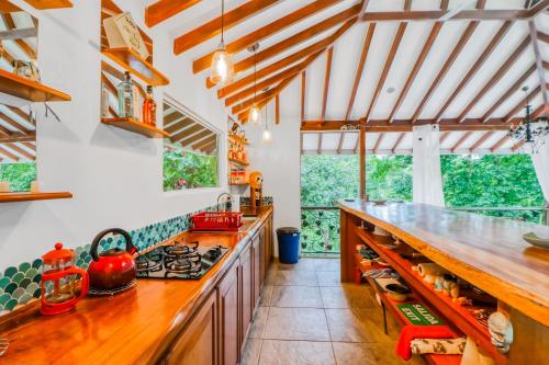 a kitchen with wooden counters and a stove top oven at Lost Pools Bungalow in Uvita