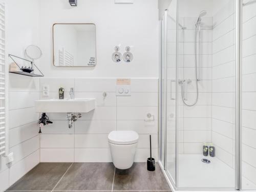 a bathroom with a shower and a toilet and a sink at Limehome Dresden Wallstraße - Digital Access in Dresden
