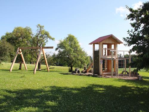 a park with a wooden swing set and a gazebo at Haslacher Hof in Waging am See