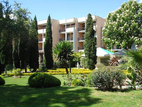 a large apartment building with trees and a garden at Domus Aurelia in Rome
