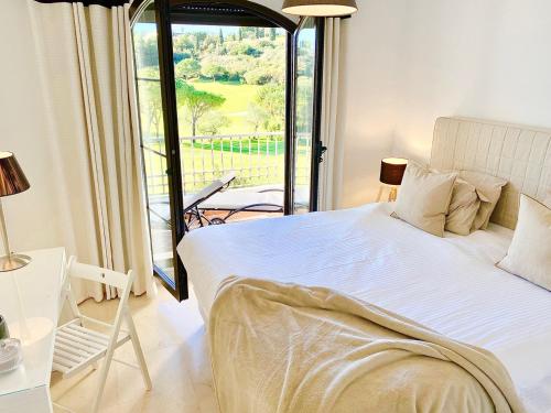 a bedroom with a large bed and a balcony at Buenavista Golf La Torre in Málaga