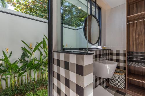 a bathroom with a sink and a mirror at Lamun at Canggu in Canggu