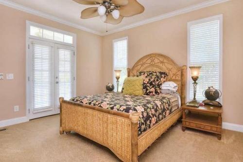 a bedroom with a bed and a ceiling fan at A Gift From Heaven in Oak Island