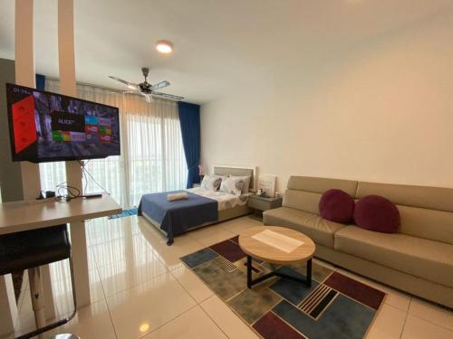 a living room with a couch and a bed at Nins Evo Bangi in Bangi