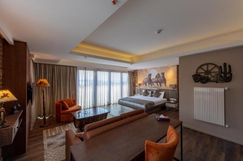 a living room with a couch and a bed and a table at Riva's Moda in Istanbul