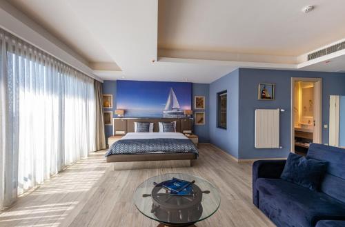 a bedroom with blue walls and a bed and a couch at Riva's Moda in Istanbul