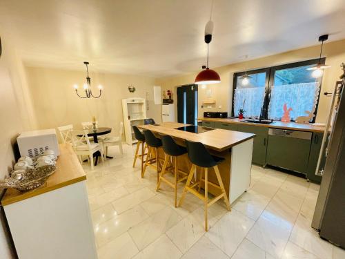 a kitchen with a table and chairs in a room at Vila Montana Valiug in Văliug