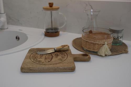 a bathroom counter with a cutting board and a whisk at Chambre Cosy Chic in Challans