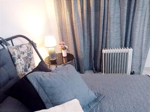 a bedroom with a bed and a table with a lamp at Estudio Paz in Lloret de Mar