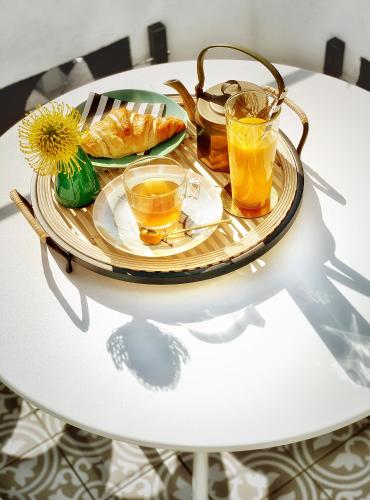 a tray with two glasses of orange juice on a table at White Elephant Palm Beach in Palm Beach