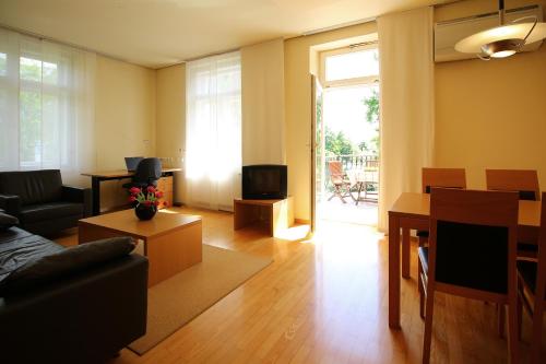 a living room with a couch and a tv at Apartments Villa Boltez in Kranj