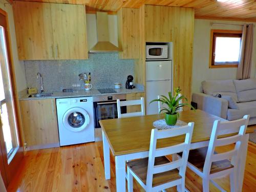 a kitchen and dining room with a table and a stove at Quinta da Resteva-Chalé do RIBEIRO in Vieira do Minho