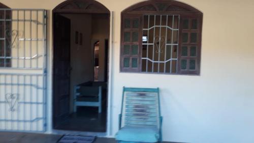 a door of a house with a staircase next to it at Aluga-se casa perto da orla para temporada. in Alcobaça