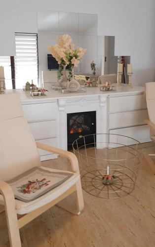 a living room with a table and a fireplace at Duplex Marquis in Braşov