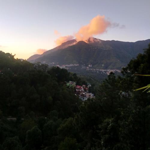 a view of a mountain with smoke coming out of it at AMBIKA HOME STAY in Solan
