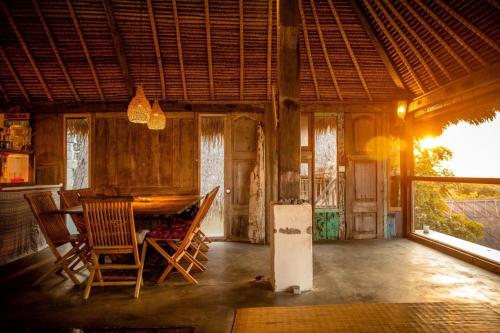 a room with a table and chairs in a house at Vertical House Bali in Uluwatu