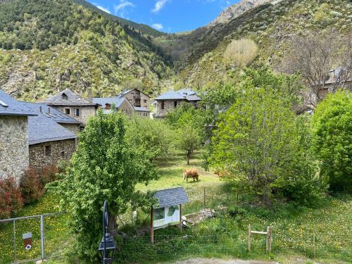 a horse grazing in a field in front of a mountain at Casa Rural Era de Ferro in Erill la Vall
