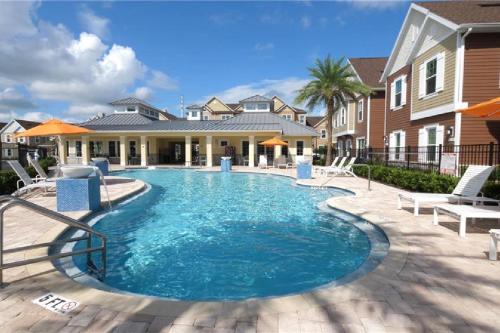 a swimming pool in front of a house at Themed Disney House 5 min to Disney Parks, Heated Pool, Jacuzzi, Gym and more in Orlando